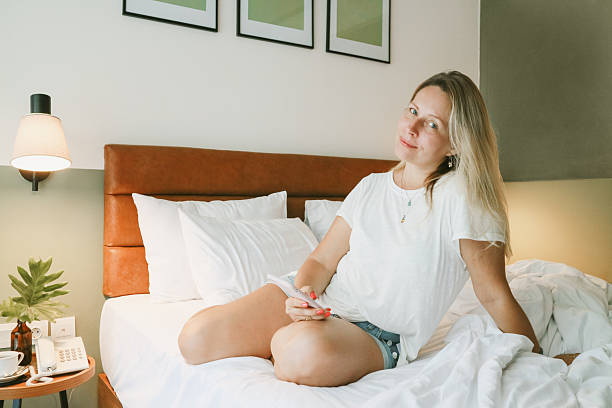 istock woman using smartphone in bedroom 2247835908