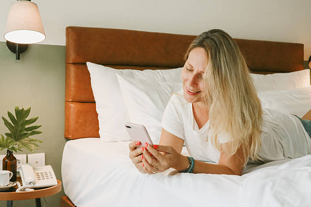 istock woman using smartphone in bedroom 2247835945