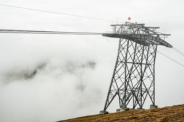 Tower Emerges From Fog Along The Eiger Express Gondola in the Swiss mountains