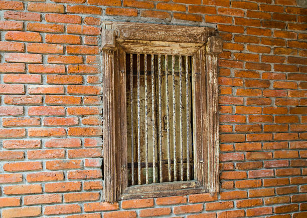 istock Vintage rusty metal window on red brick wall. 2247839127