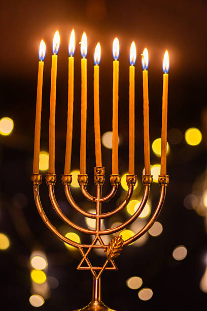istock hanukkah Menorah - Candles With Glittering And David Stars 2247839778