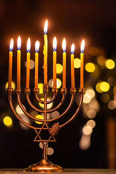 istock hanukkah Menorah - Candles With Glittering And David Stars 2247839817