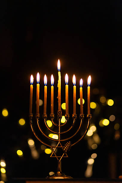 istock hanukkah Menorah - Candles With Glittering And David Stars 2247839863