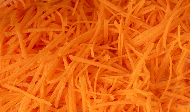 istock Fresh Finely Grated Carrots Textured Background, Raw Carrot Pieces Closeup Pattern 2247841459