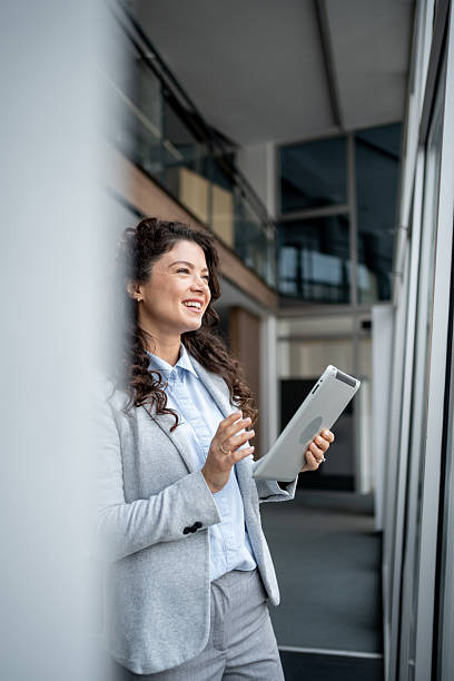 istock Businesswoman standing in office using digital tablet 2247843642