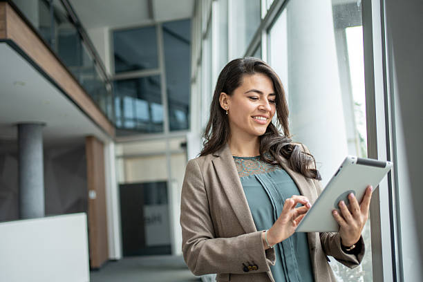 istock Smiling businesswoman using tablet in modern office 2247848351