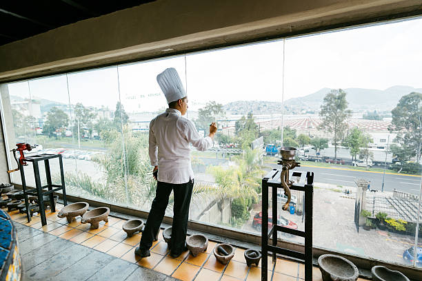 Chef preparing savory meat inside dimly lit food truck, crafting authentic mexican street food during nighttime culinary rush