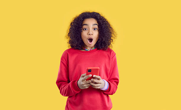 istock Amazed biracial girl shocked by text on cell 2247848836