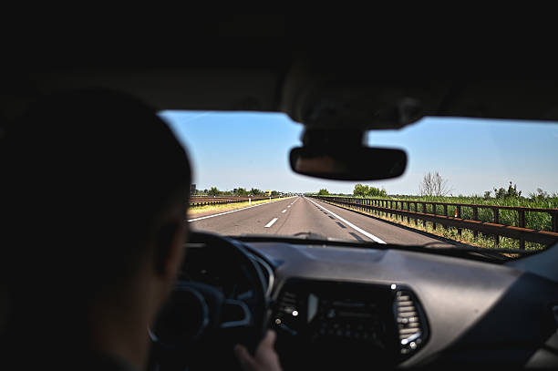 istock Driver's perspective travelling on a multi-lane highway under a clear blue sky 2247849909