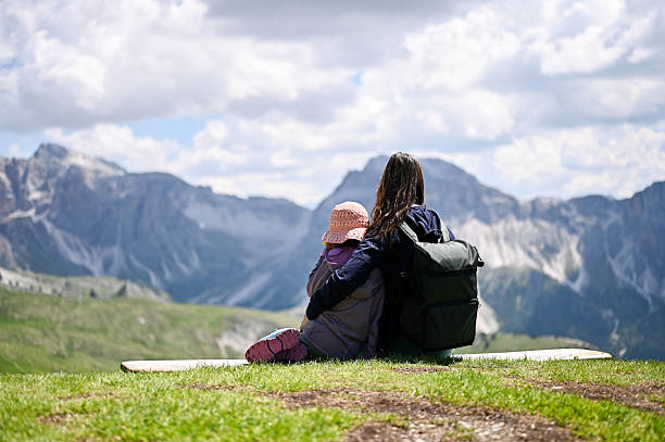 istock Mother and daughter embracing while enjoying mountain view. Seceda 2247850348