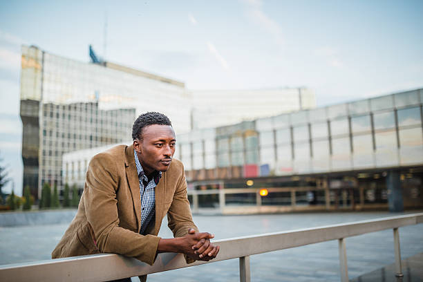 istock Pensive Man Leaning on Railing in Urban Setting 2247852060