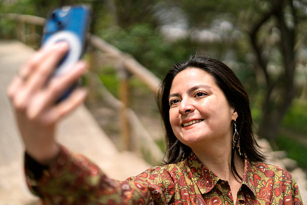istock Young woman taking selfie with smartphone in nature 2247853552