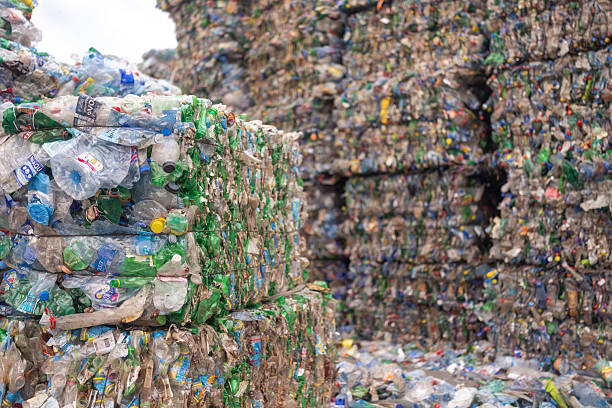 istock Massive bales of used plastic bottles stacked at a recycling site 2247856564
