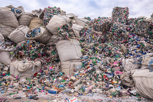 istock A substantial pile of mixed plastic waste, such as bottles and bags, some packed inside large bags for collection 2247856578