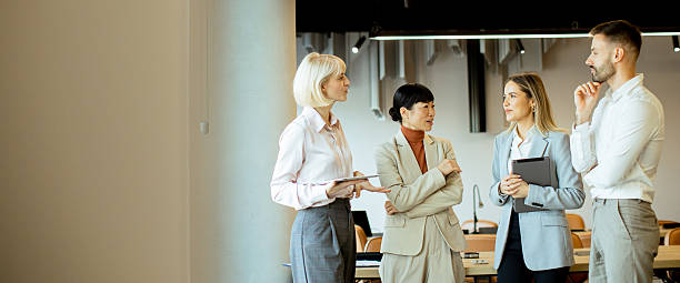 istock Business professionals engage in discussion during a meeting in a modern office space 2247856640