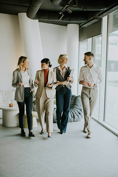 istock Business professionals engage in casual meeting in modern office setting 2247856682