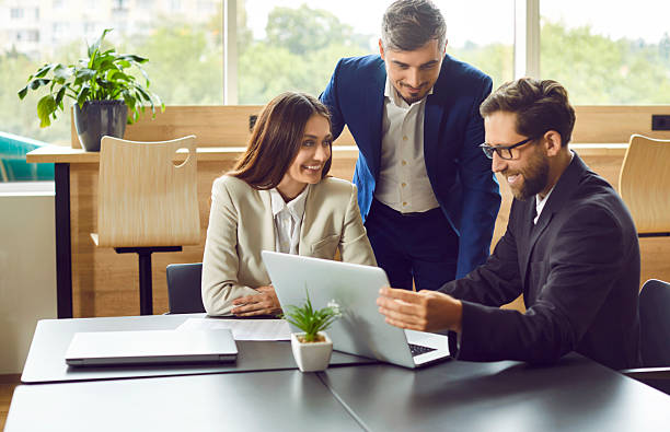 istock Business man showing work project to his colleagues on laptop computer in office. 2247858507