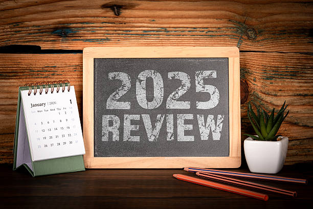 istock 2025 Review. Desk Calendar and Chalkboard Message 2247858627