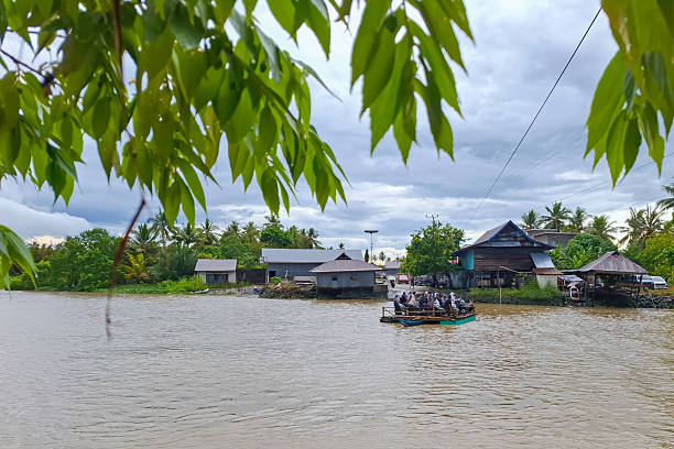 istock Boats Navigate Muddy River Amidst Tropical Village 2247858656