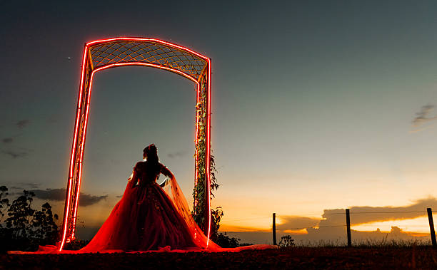 Elegant view of two white wedding dresses displayed in the window of a bridal boutique at night.