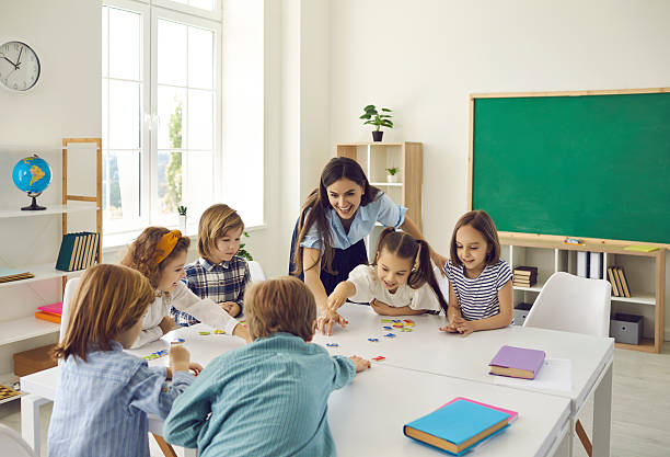 istock Female teacher and junior high school students have fun putting together puzzles in class. 2247862703