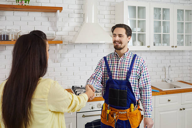 istock Male plumber handshake satisfied female client 2247862866