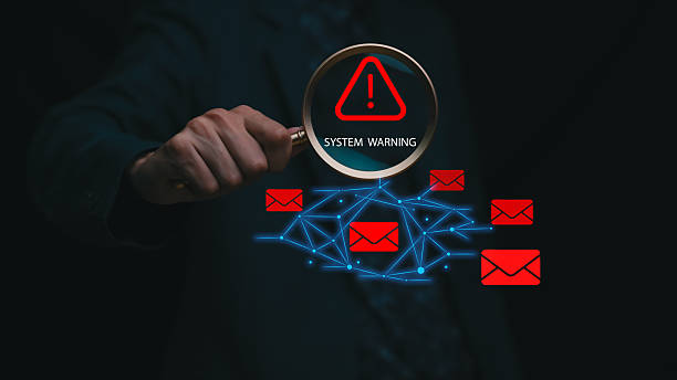 istock A digital system warning concept showing a magnifying glass highlighting red alert icons and email threats across a connected network, representing cybersecurity risk, data breach detection, and online threat analysis. 2247864821