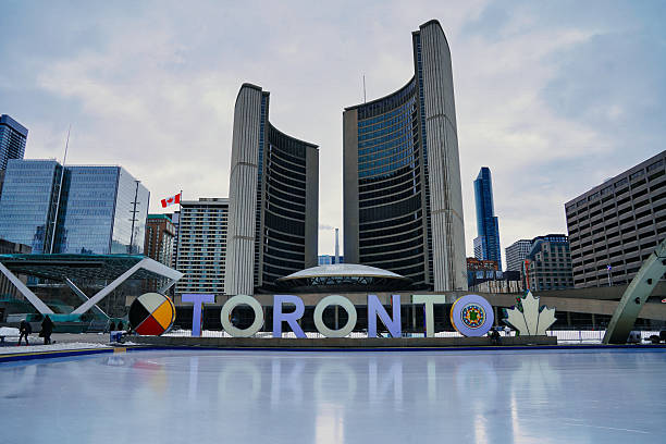 Iconic Toronto Sign at historic Nathan Phillips square with the Toronto City Hall and the open air skating rink on Queens street in downtown Toronto,Ontario,Canada