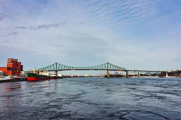 Montreal,Canada,January 6,2022-Winter View of the iconic Jacques Cartier Bridge,a steel truss cantilever bridge crossing the Saint Lawrence River the Montreal island to Longueuil,built in 1930 in Montreal,Quebec,Canada