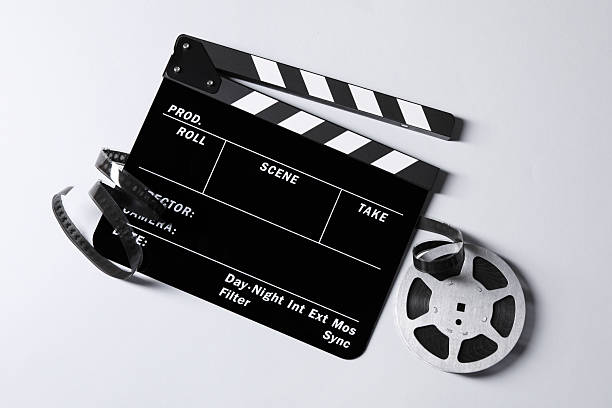 istock Clapperboard and film reel on grey background, flat lay 2247876750