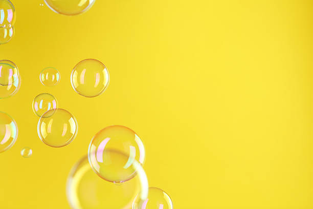 istock Beautiful transparent soap bubbles on yellow background, space for text 2247877694