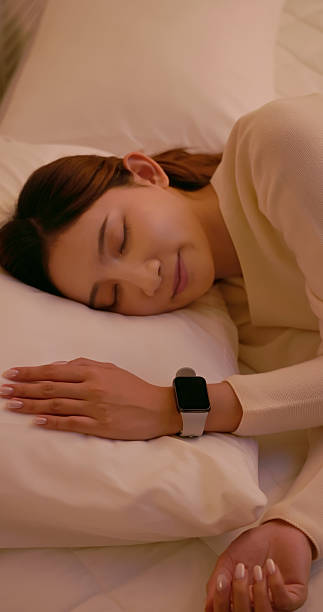 istock asian female wear smart watch sleeping home 2247881475