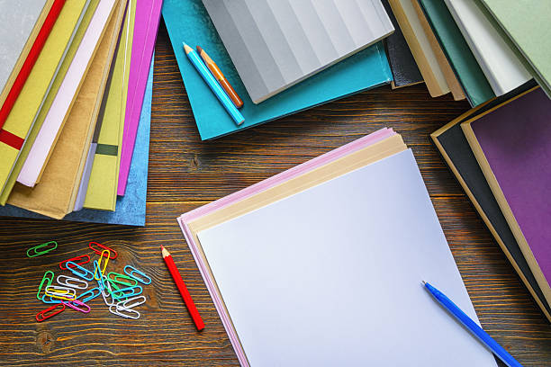 Large stack of files, documents, paperwork on desk