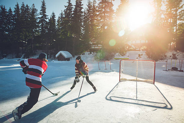 istock Young men play pond hockey, Whistler 2247885492