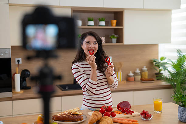 istock Woman vlogger filming cooking video in kitchen 2247891034