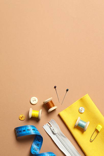 istock Set of tailoring accessories on light background, top view 2247891047