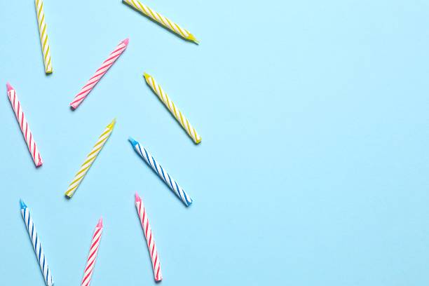 istock Multi-colored holiday candles on a blue background, flat lay. Birthday concept 2247891181