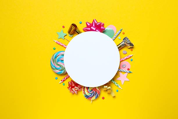 istock Birthday party card on a yellow background with copy space for text, top view 2247891293