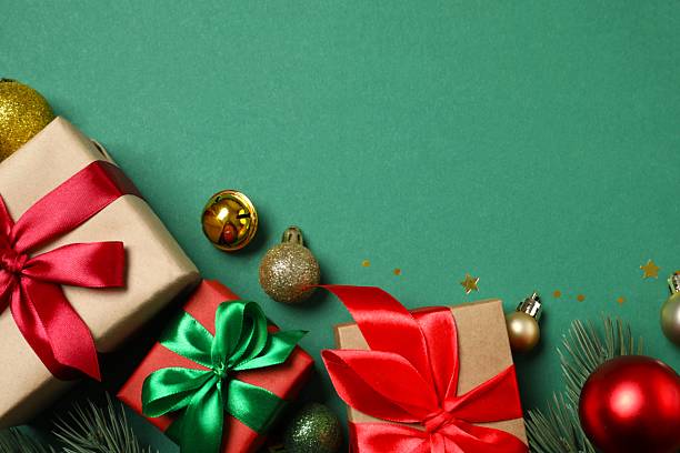istock Christmas gift boxes and decorations on green background,  seasonal greeting 2247892779