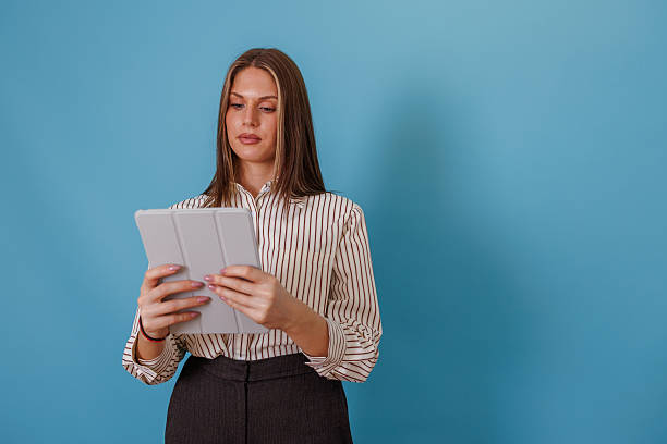 istock Professional business woman using digital tablet, organizing schedule, staying connected in a modern workplace 2247894580