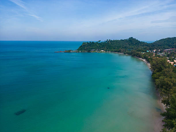 istock Tropical beach rainforest island serenity turquoise ocean coconut palm tree from above. 2247896421