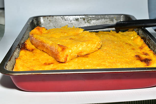 A casserole made from cottage cheese and pumpkin sits in a brown baking sheet. Side view.