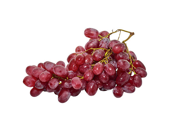A bunch of red grapes lies on a white background.