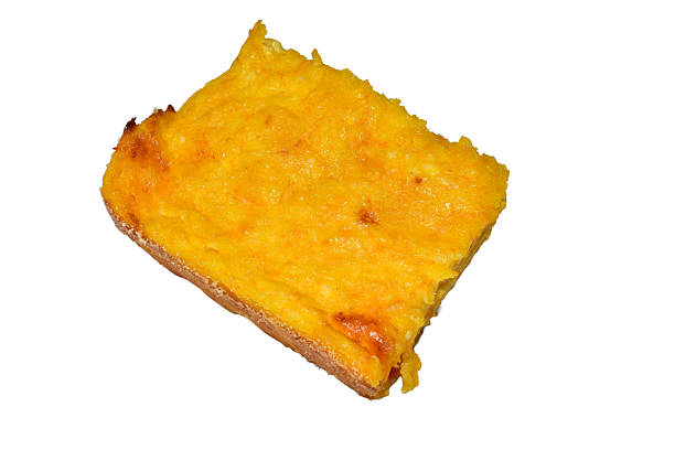 A piece of cottage cheese and pumpkin casserole lies on a white background.