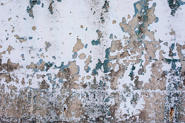Grungy background, concrete wall with stained cracked paint detail