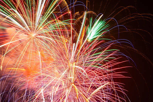 istock Bright colorful fireworks explode in the dark night sky during a holiday celebration creating a magical atmosphere of joy and happiness for New Year party 2247898506