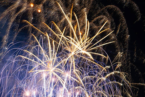 istock Beautiful bright colorful fireworks explode in the dark night sky during a large holiday celebration creating a magical atmosphere of pure joy and happiness for a wonderful New Year party 2247898508
