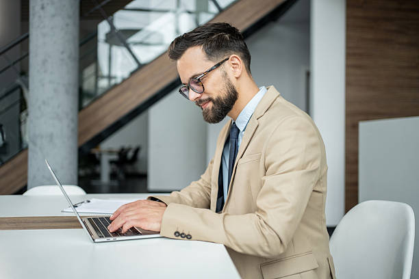 istock Businessman working on laptop in modern office 2247899252