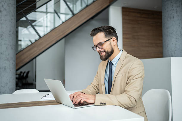istock Young businessman typing on laptop smiling in modern office 2247899273