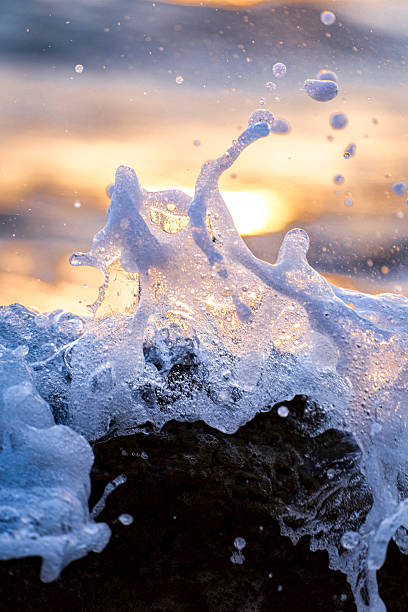 istock Patterns of sea waves crashing against rocks. 2247904783